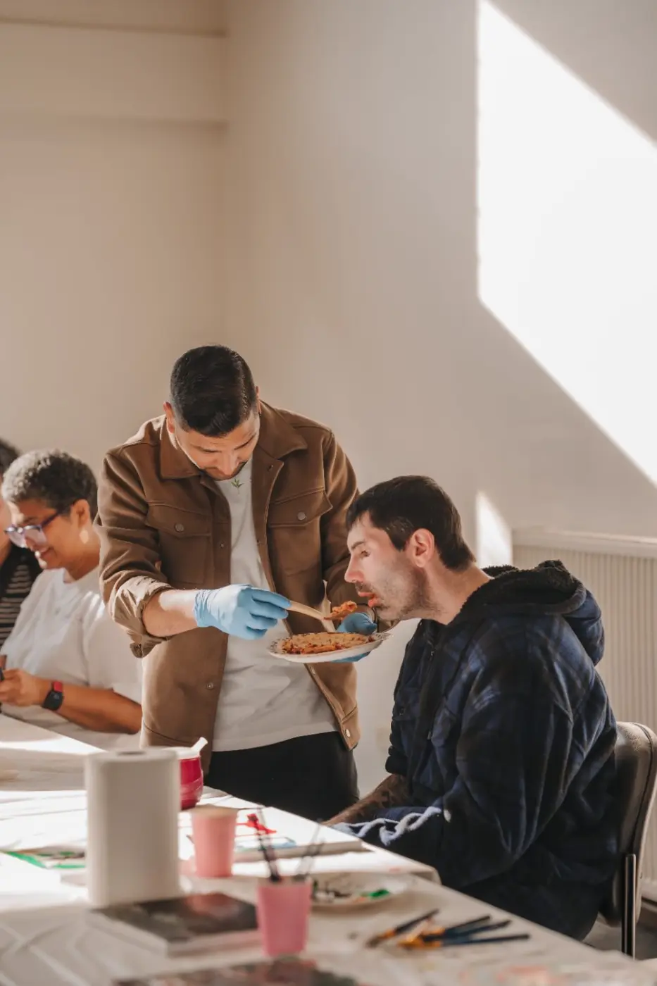 Participants focused on a painting activity at a table