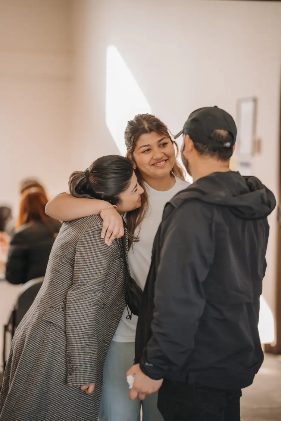 Team members sharing a hug at a group event