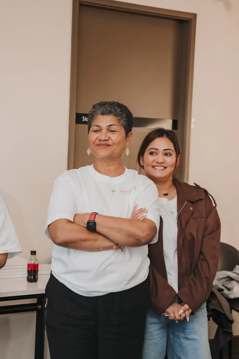 Two team members smiling together at an event