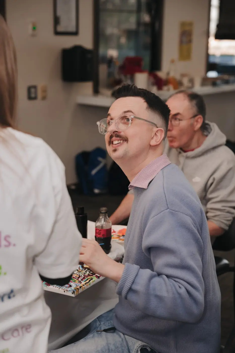Participant smiling and chatting at a group activity