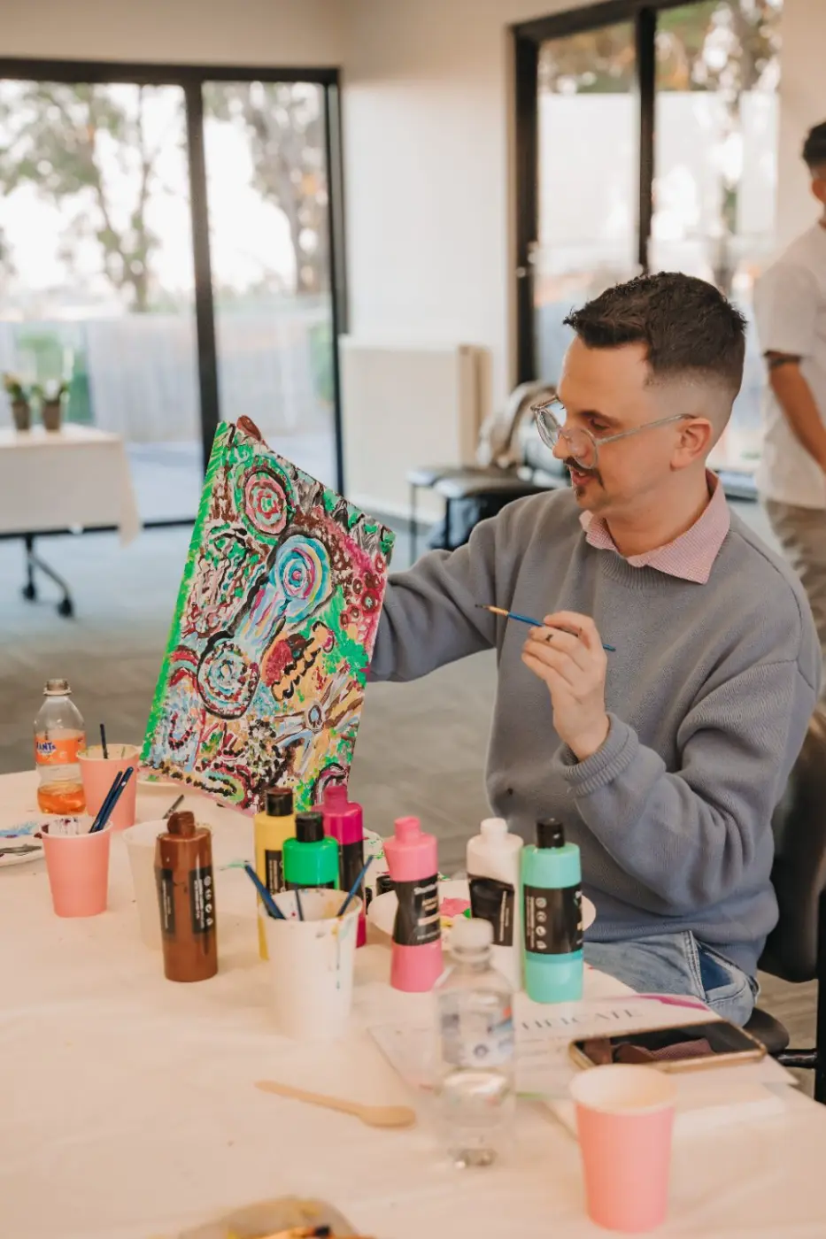 Participant proudly showing a finished painting